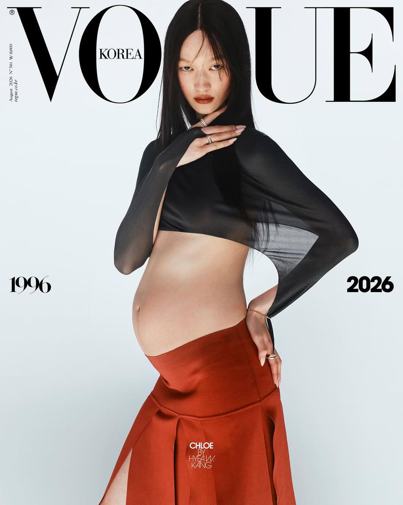 Pregnant model Chloe Oh poses in a sheer black cropped top and a rust pleated skirt on a Vogue Korea cover.
