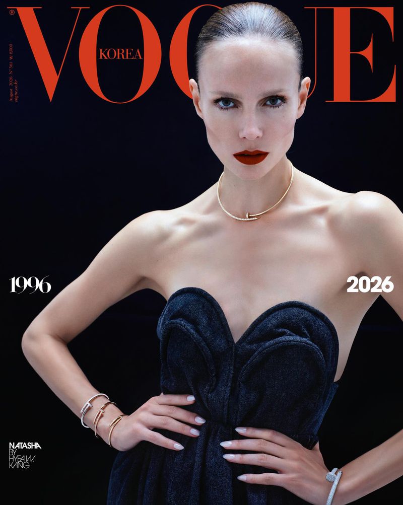 Model Natasha Poly posing in a sculpted black strapless top with gold nail jewellery for a Vogue Korea magazine cover.