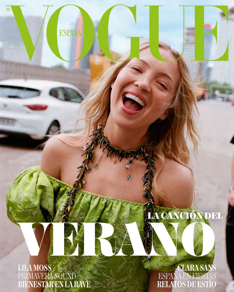 Model Lila Moss laughing outdoors wearing a green off-shoulder dress and beaded necklace for Vogue España August 2026 cover