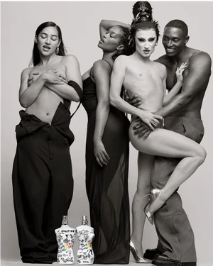 Gottmik, Mecca Mozelle, and models posing together above Jean Paul Gaultier Pride fragrance bottles in studio.