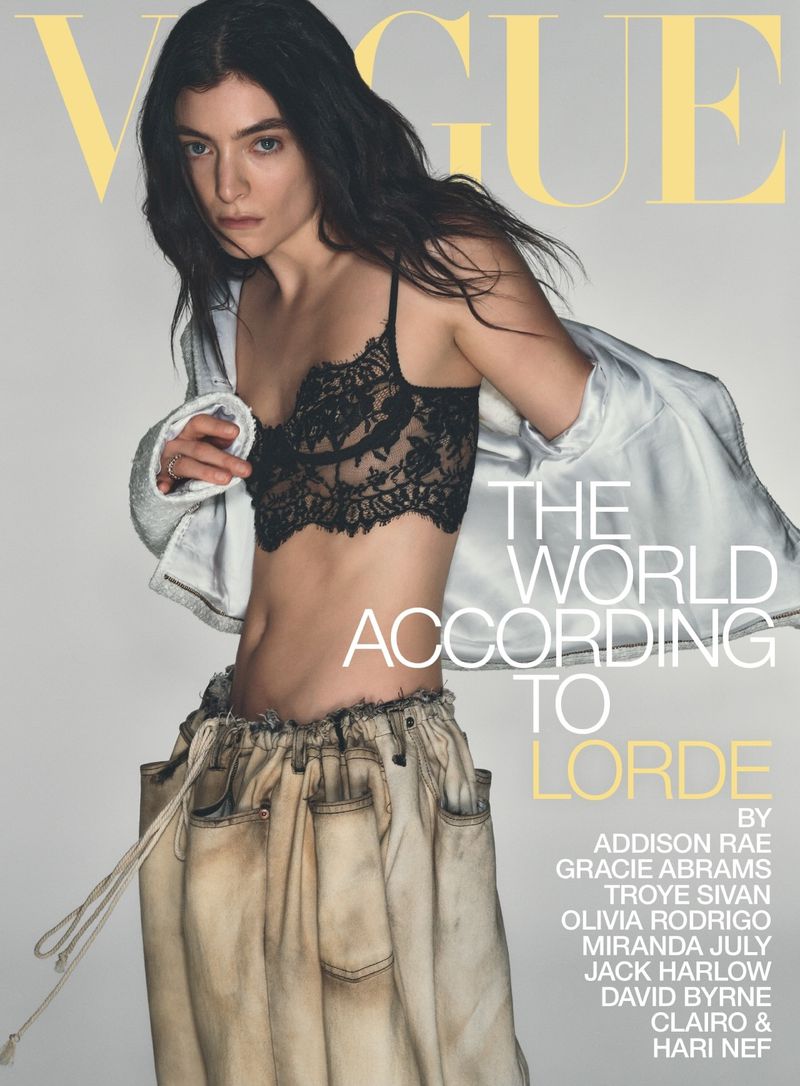 Vogue magazine cover featuring Lorde in a black lace bra, white jacket, and deconstructed jeans. The magazine title is in yellow font.