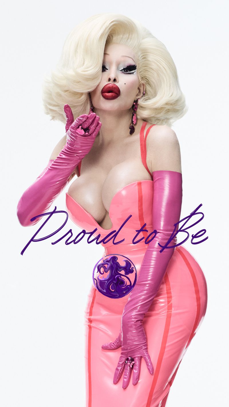 Amanda Lepore in a pink latex dress and long pink gloves blowing a kiss against a white background for the Oribe Pride Campaign