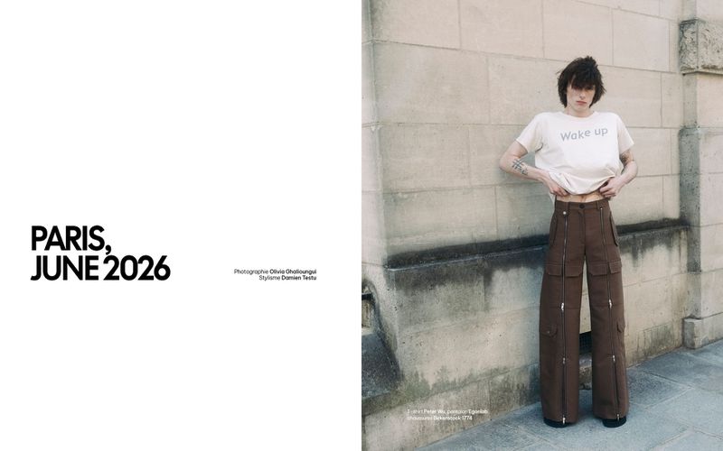 Editorial layout featuring a male model in a white t-shirt and brown cargo pants standing against a stone wall
