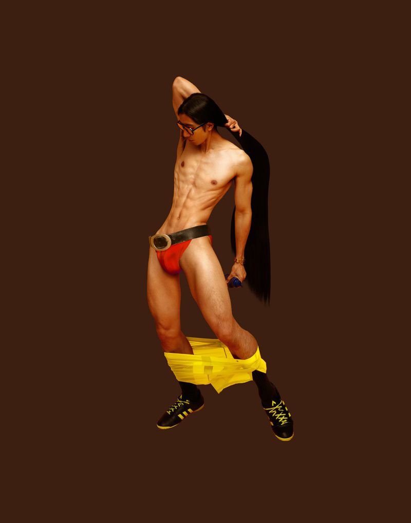 Man in red briefs, yellow underpants down around his ankles, and glasses poses with long hair on brown background.