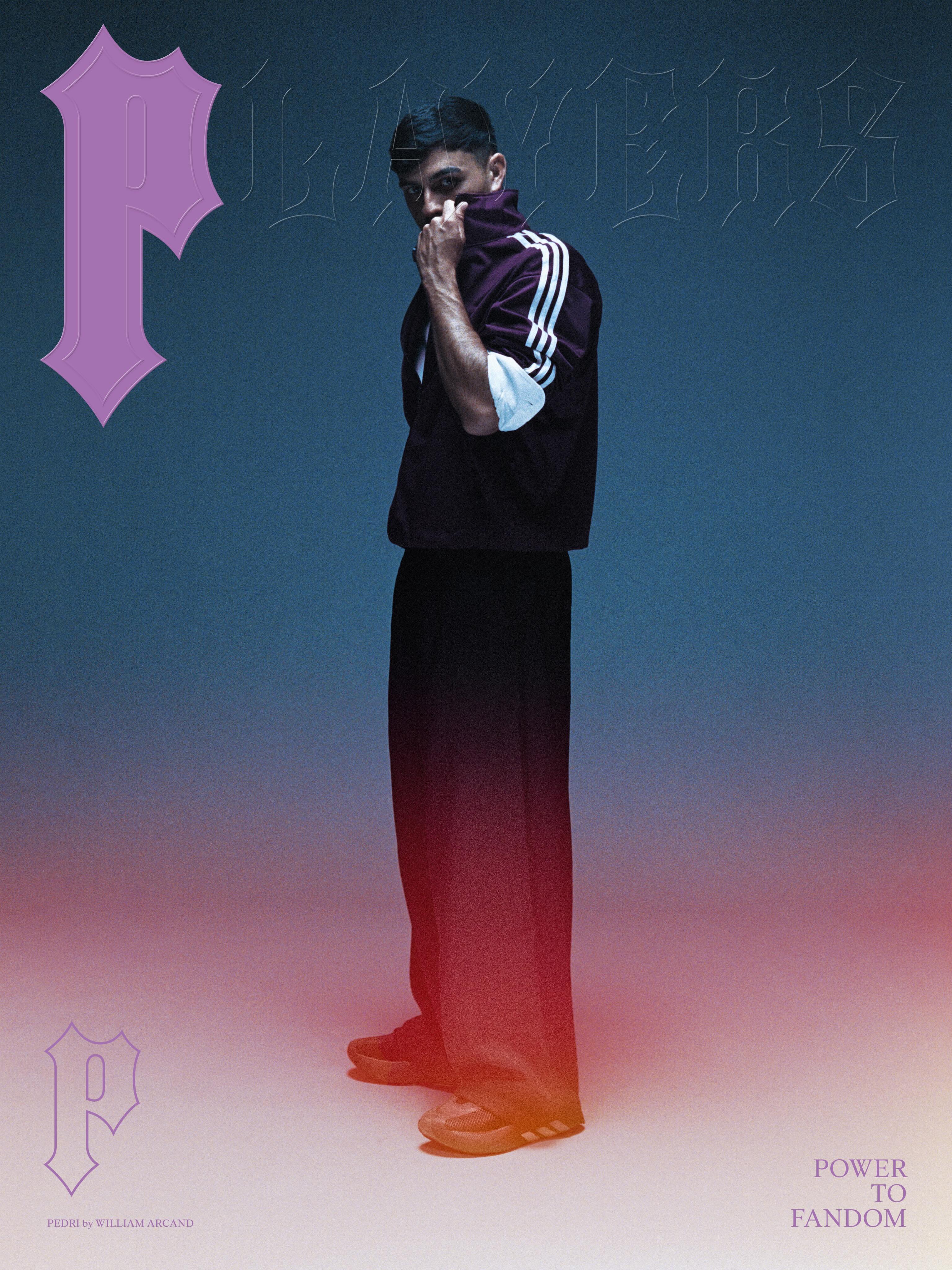 Footballer Pedri wearing a burgundy track jacket and wide trousers posing against a blue and red gradient studio backdrop.