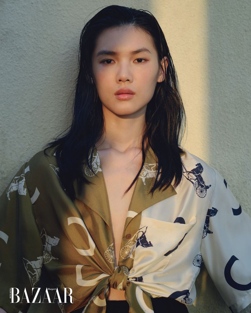 Model Du Si Ying wearing a patterned silk shirt with horse motifs for Harper's Bazaar Hong Kong.