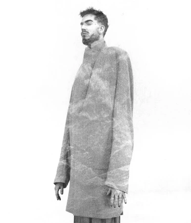 Adam Lambert wearing an oversized coat against a plain white background for The Face China, photographed by Arcin Sagdic
