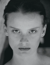 Close-up monochrome portrait of a model with intense expression and dark hair