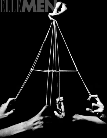 Hands manipulate a string game forming geometric shapes against a dark background, monochrome editorial style, visual art.