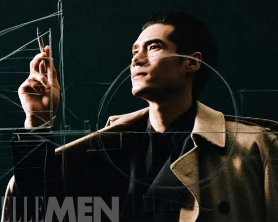 Portrait of a dark-haired Asian man in a trench coat, holding a drawing tool, with geometric lines overlaid and the Elle Men logo.