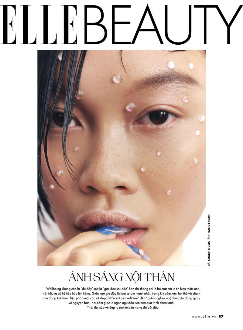 Close-up of a woman's face with skincare dots on her skin, featured on the cover of Elle Beauty magazine. Beauty concept.