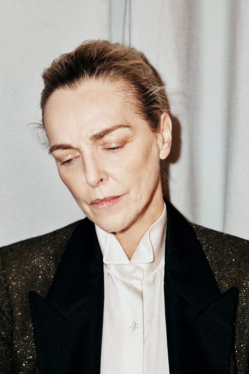 Portrait of model Simonetta Gianfelici wearing a white collared shirt and dark blazer against a plain background