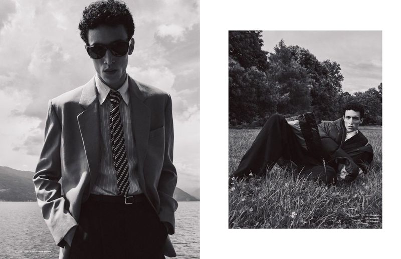 Black and white fashion shot of a man in a suit outdoors by water, with a second image of him lying in grass.
