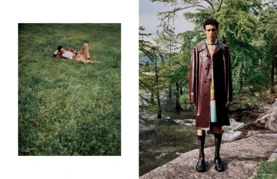 Model standing on rocky shore wearing dark leather coat in Arena Homme China editorial Strayed Into Emerald Wilds