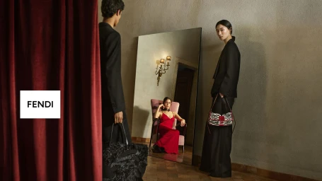 Chu Wong holding a zebra-print handbag alongside models posed with a full-length mirror and red velvet curtain for Fendi.