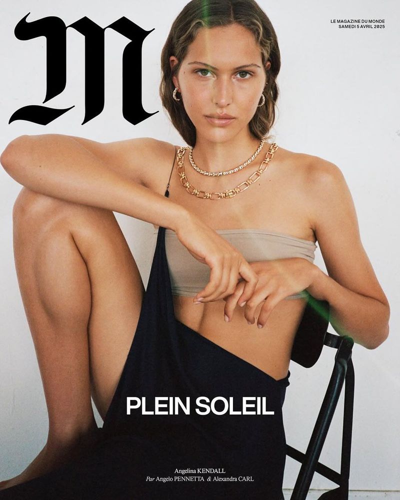Magazine cover featuring a model wearing a bandeau top and dress straps, seated on a chair with a large 'M' logo in the background.