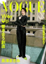 Masami Nagasawa posing in a black pleated suit and lime green pointed shoes on a terrace plinth for the Vogue Japan cover.