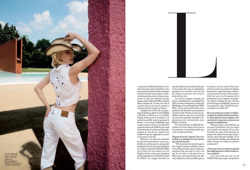 Blonde woman wearing white denim vest and jeans with a cowboy hat leaning against a pink wall for Vogue Mexico.