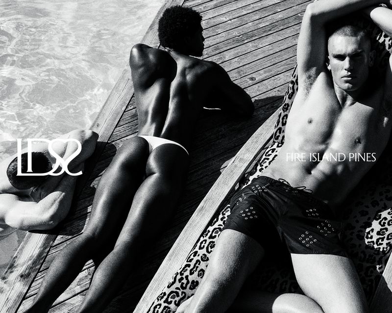 Black and white image of three men in swimsuits lounging on wooden planks by a pool, with the text 'Fire Island Pines'.