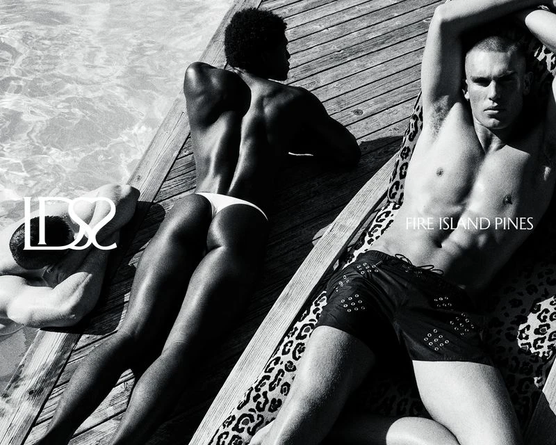 Black and white image of three men in swimsuits lounging on wooden planks by a pool, with the text 'Fire Island Pines'.