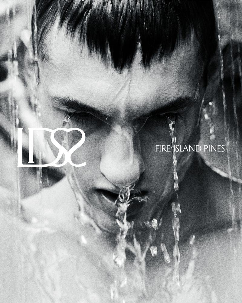 Monochrome close-up of a man's face with water cascading down, against a blurred background with text overlay, creating a dramatic effect.
