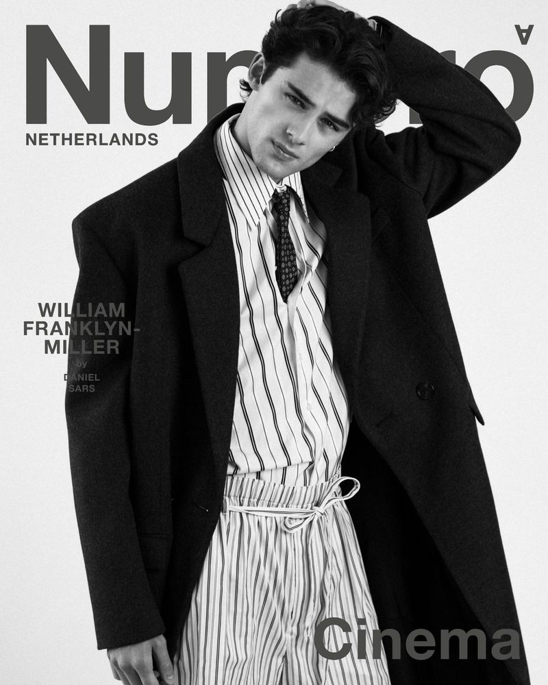 William Franklyn-Miller wearing an oversized dark coat, tie, and striped shirt on a Numéro Netherlands magazine cover.