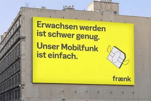 Large bright yellow billboard on an urban building facade featuring German text, a winged SIM card illustration, and the fraenk logo.