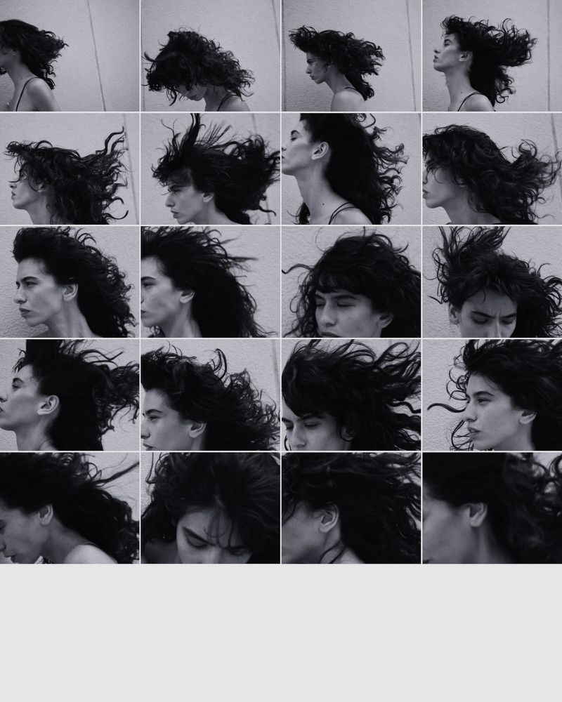 A black and white contact sheet of a woman with long dark wavy hair moving her head, creating a dynamic effect against a light background.