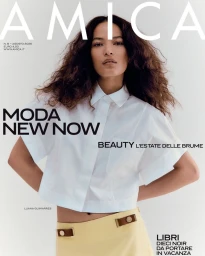 Model Luana Guimarães wearing a crisp white short-sleeved shirt and pale yellow skirt against a white studio background.