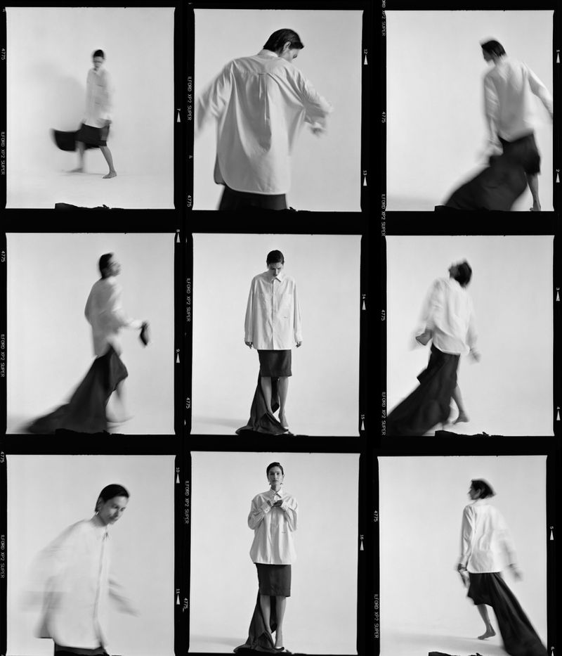 Black and white 3x3 contact sheet grid of model Paulina Kube wearing an oversized white shirt and dark skirt against a white background.