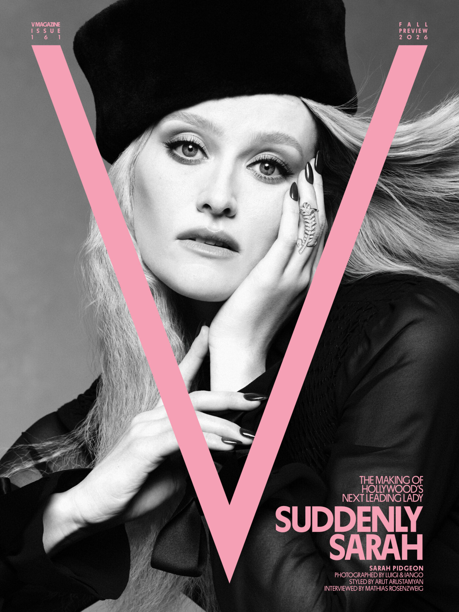 Portrait of actress Sarah Pidgeon wearing a black beret and dark top with long blonde hair streaming back against a plain grey background