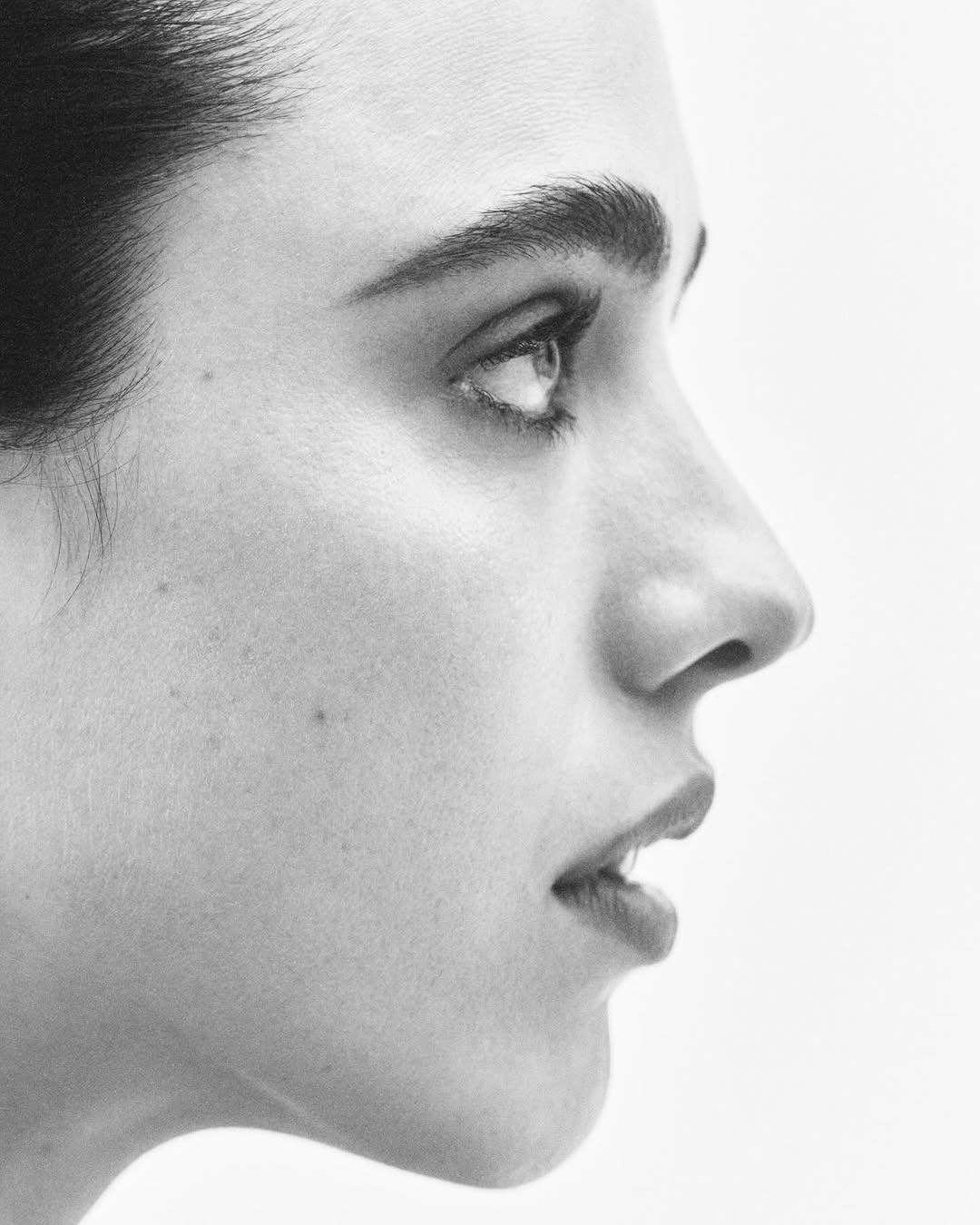 Close-up profile portrait of Margaret Qualley in monochrome for Vogue Australia by photographer Josh Olins.