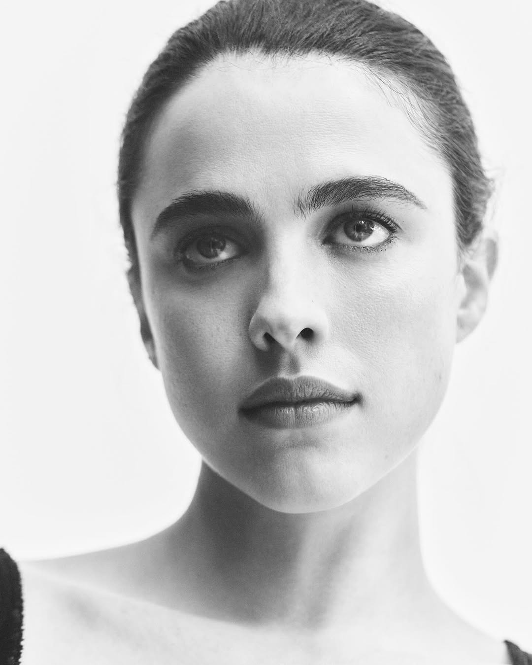 Close-up portrait of actress Margaret Qualley with dark hair pulled back against a plain white background for Vogue Australia.