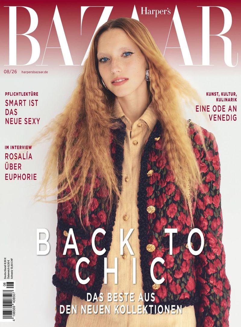 Fashion magazine cover featuring a model with long crimped blonde hair wearing a patterned red and black textured jacket over a beige shirt.