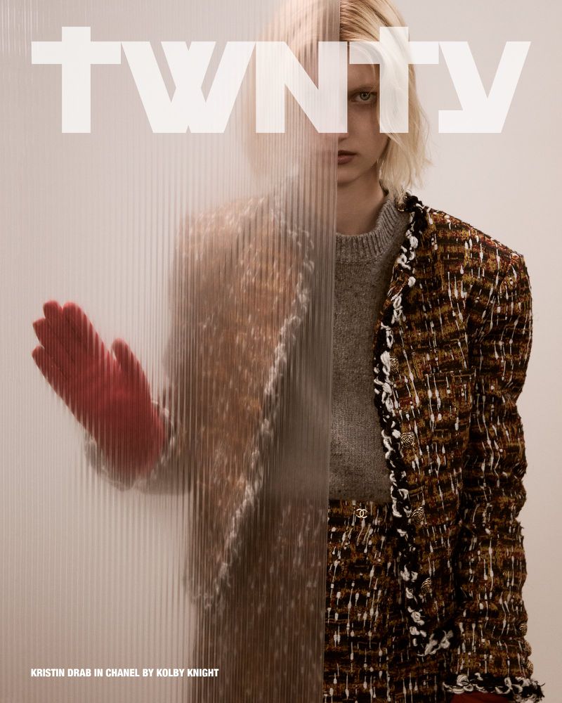 Model Kristin Drab viewed through fluted glass wearing a textured Chanel tweed jacket and a red glove, from Twnty Magazine.