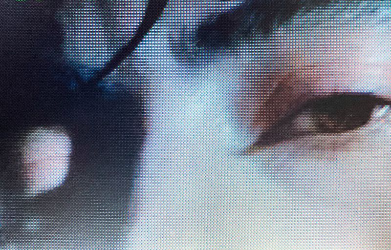 Cropped eye close-up with a pixelated, abstract style. The image focuses on the detail and texture of digital representation.