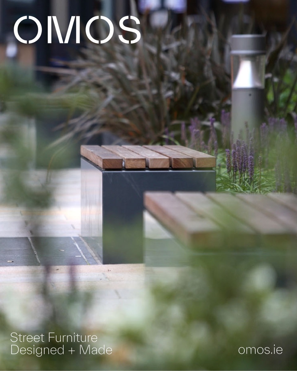 OMOS modern outdoor street furniture featuring wooden slat benches surrounded by urban planting and a bollard light.