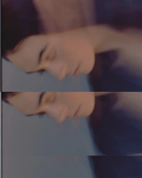 Close-up soft-focus profile of a person with dark hair resting with eyes closed against a muted blue-grey background.