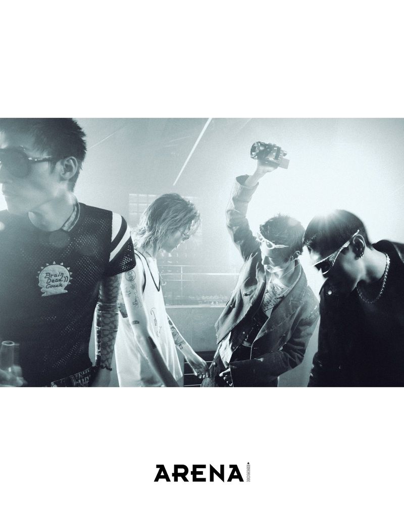 Group of four men in streetwear and sunglasses posing in a dimly lit, hazy club environment for an Arena Homme Plus editorial.