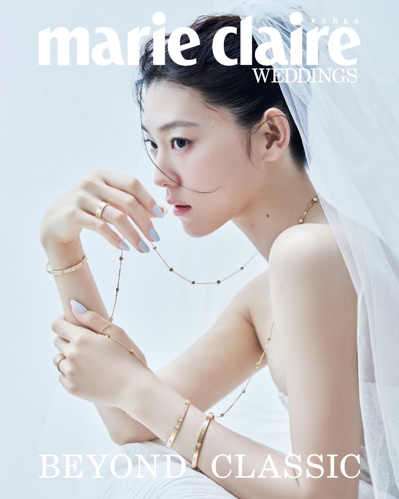 A woman wearing a bridal veil and gold jewelry gazes sideways against a clean white background, featured on a Marie Claire cover.