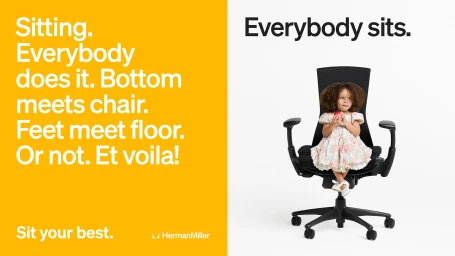Young child in a floral dress seated in an oversized black ergonomic office chair next to a bold yellow typographic advertisement.