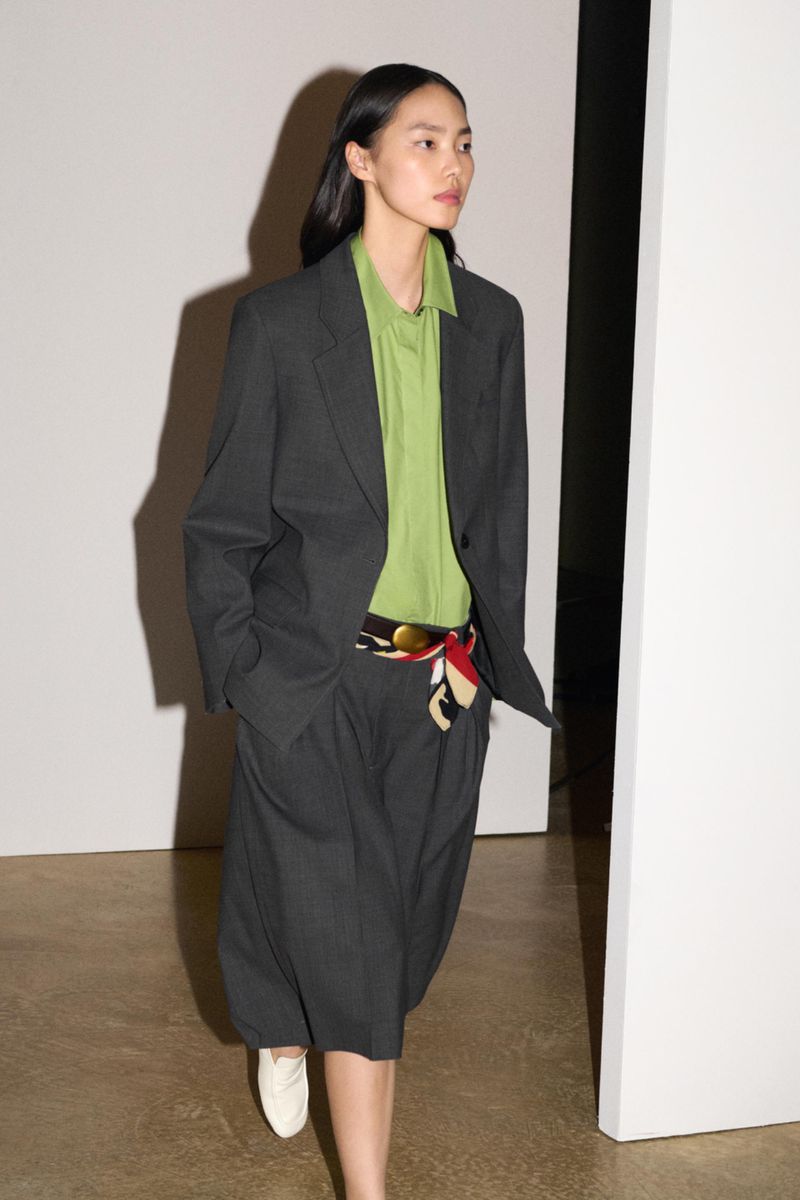 Model Jiahui Zhang walking in an oversized grey blazer, green shirt, and matching culottes for the Zara ZW A/W 2026 campaign.
