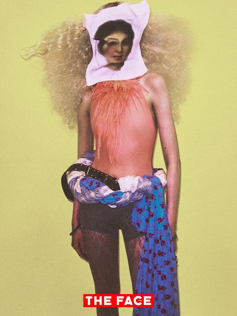 Editorial model wearing a peach feather top and printed face mask against a chartreuse studio backdrop for The Face China.