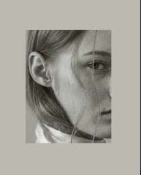Close-up portrait of model Maria Shainer showing freckles, eye, and ear while wearing a high white collar for Rokh.