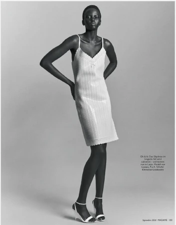 Model Ajak Dhieu wearing a textured slip dress and heels against a grey seamless background for Madame Germany