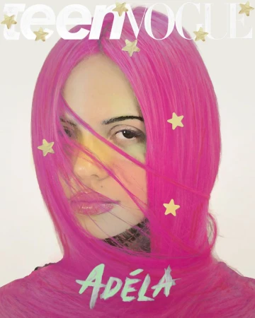 Adéla Jergová with bright magenta pink hair framing her face on the Teen Vogue magazine cover against a white backdrop.
