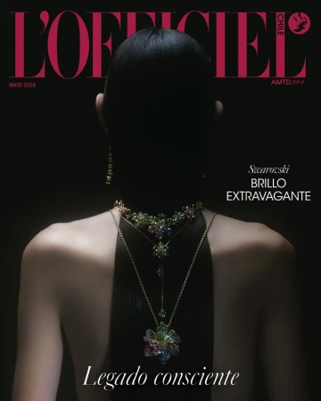 Back view of a model with sleek black hair wearing layered crystal floral necklaces against a dark background for L'Officiel Chile.
