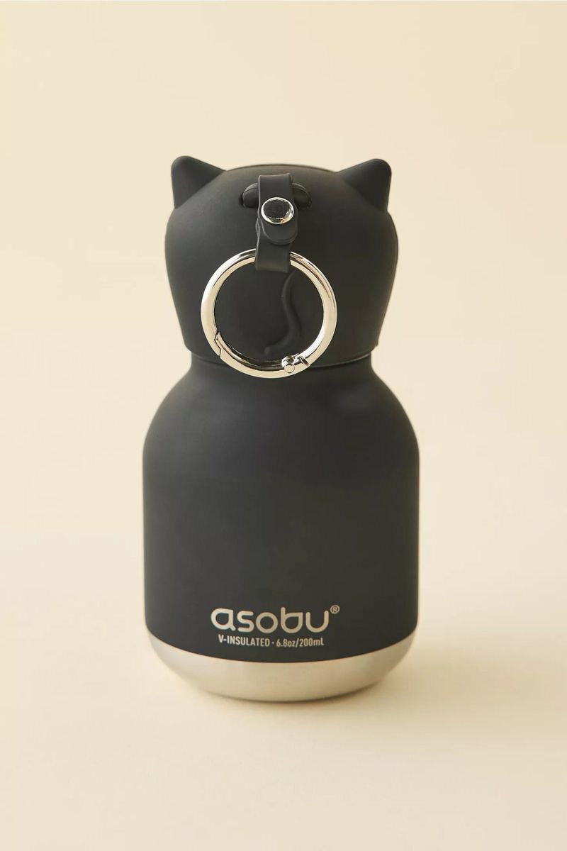 Matte black Asobu cat-eared insulated mini bottle with silver metal base set against a warm cream studio background.