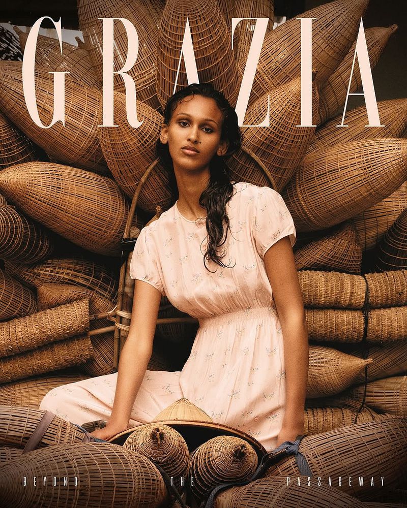 Fashion editorial shot of a woman in a pink dress surrounded by woven baskets, with the magazine title 'GRAZIA' displayed prominently.