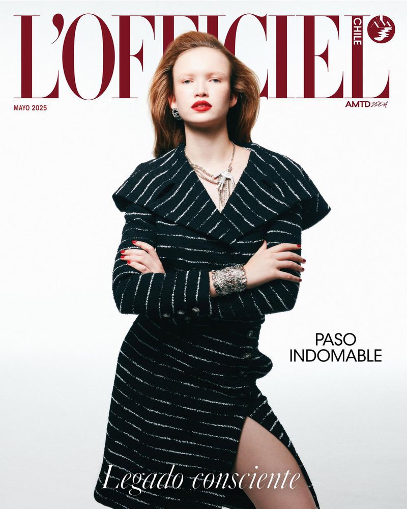 Fashion magazine cover: Woman poses in a black and white striped jacket and skirt. Red lipstick and jewelry complete the look.